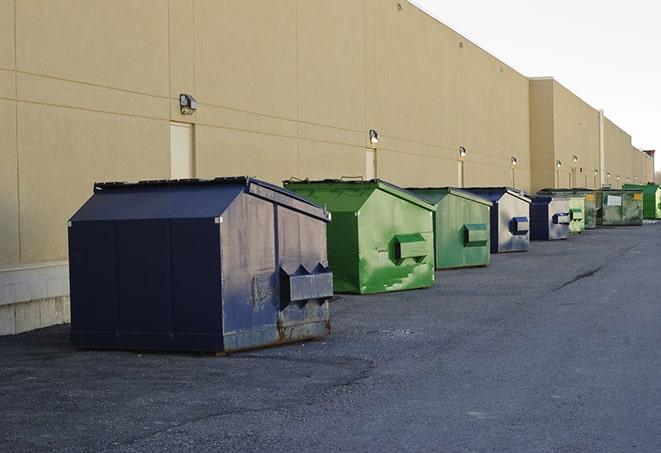 an assortment of sturdy and reliable waste containers near a construction area in Auburn